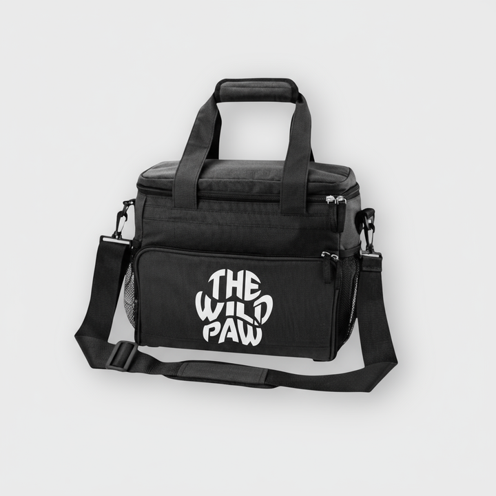 Black bag for pet's supplies with 'The Wild Paw' logo on a light gray background