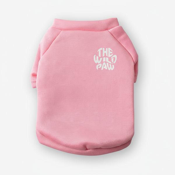 Pink dog sweater with 'The Wild Paw' logo on a white background